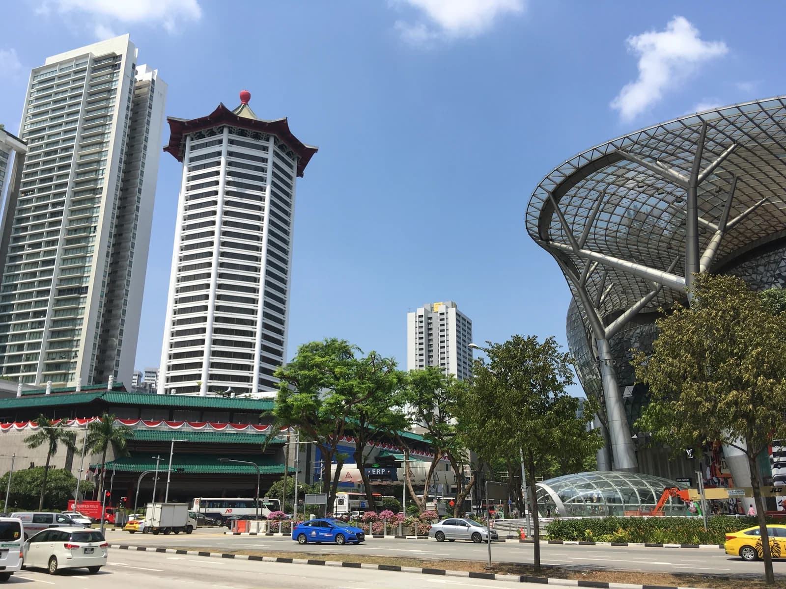 Shoppers and traffic on Orchard Road outside the ION Orchard mall