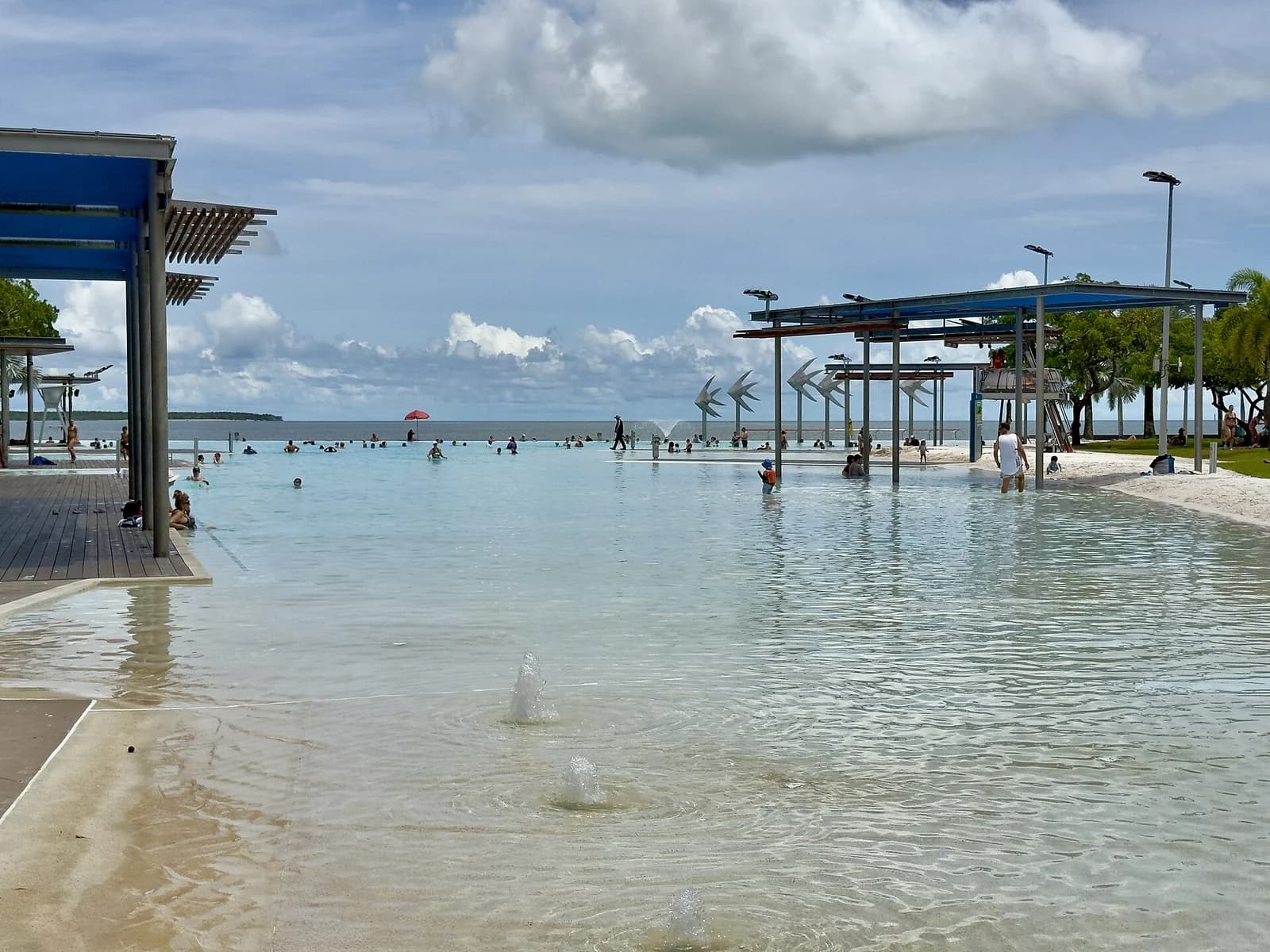 The Esplanade swimming lagoon on the Cairns waterfront with palms and the boardwalk around it