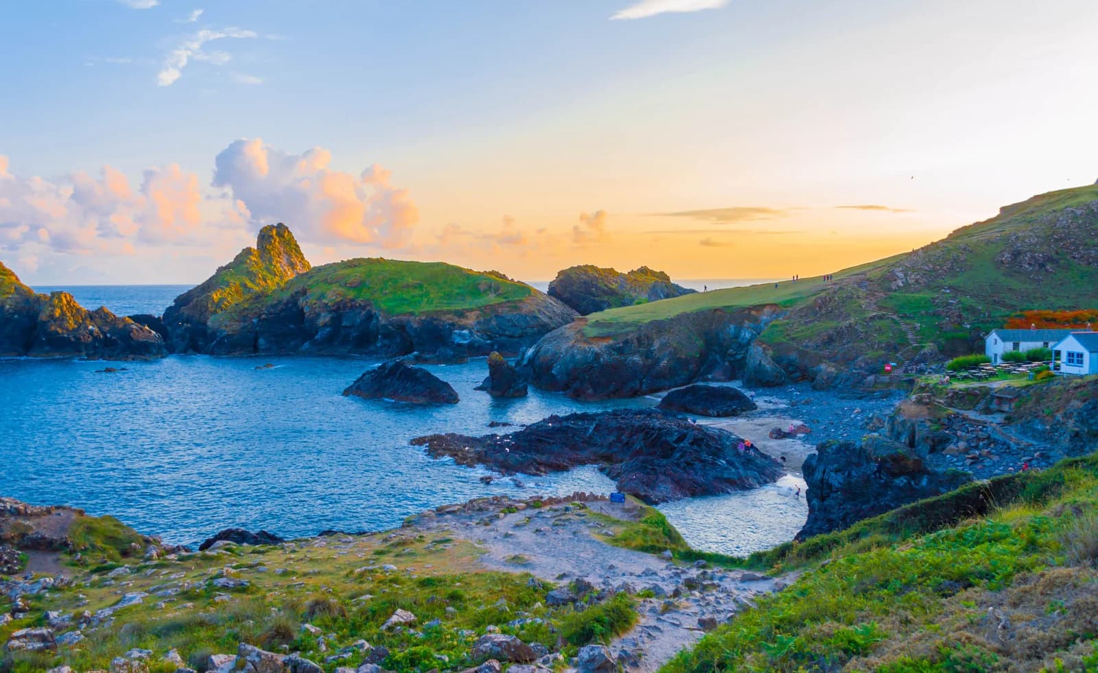 Kynance Cove on the Lizard in Cornwall at sunset, with rock stacks and the beach cafe