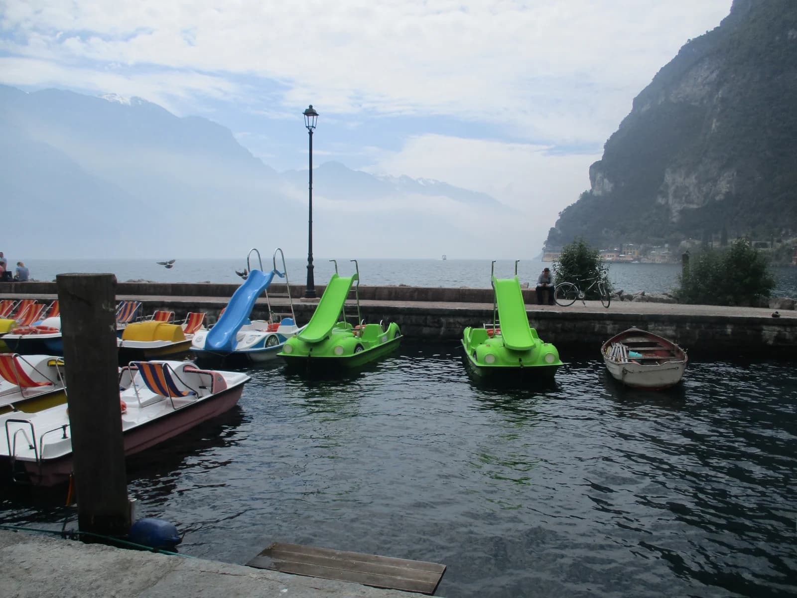 Pedal boats with water slides moored at Riva del Garda at the northern tip of Lake Garda