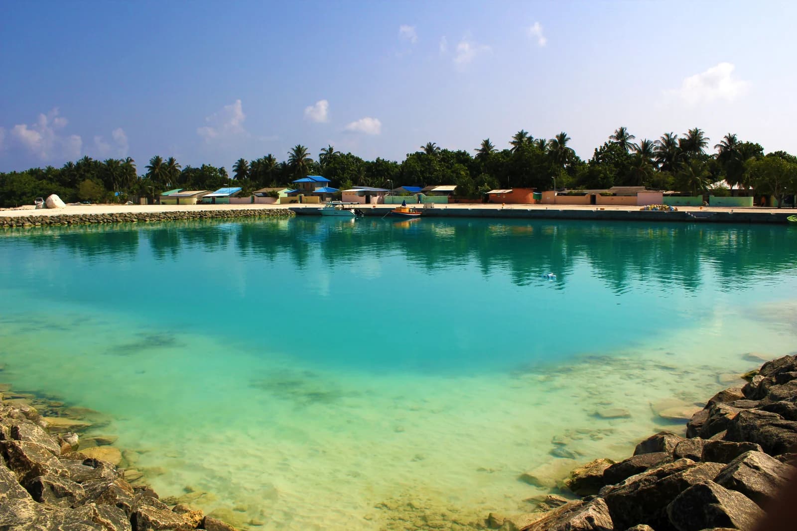 The harbour front of Ukulhas, one of the Maldives local islands where these family hotels stand, seen from the water on the approach