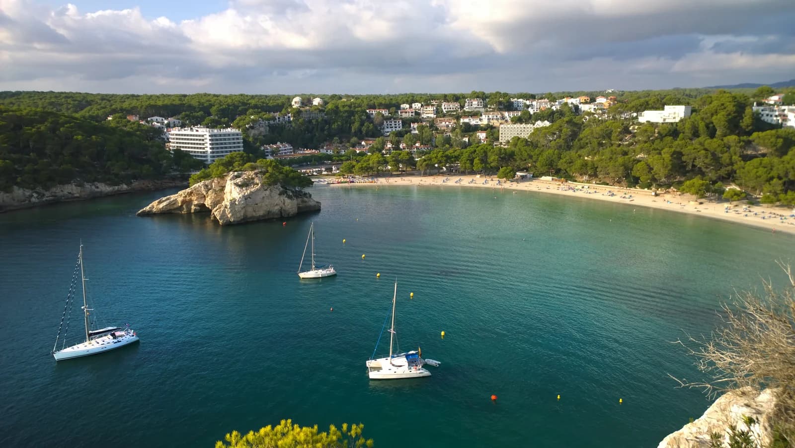 The bay of Cala Galdana on Menorca with yachts at anchor and the beach behind