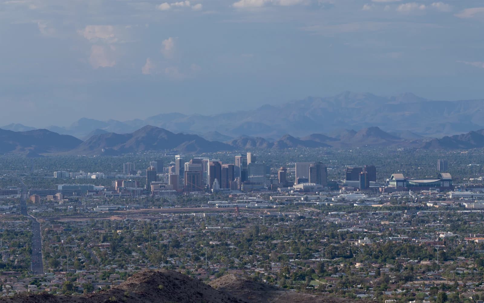 The downtown Phoenix skyline with the desert mountain ranges behind it