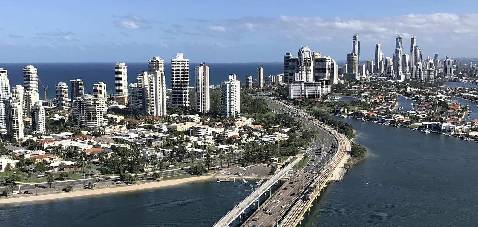 The Gold Coast skyline above Main Beach and Surfers Paradise, with the canals and the light rail bridge in front of the resort towers