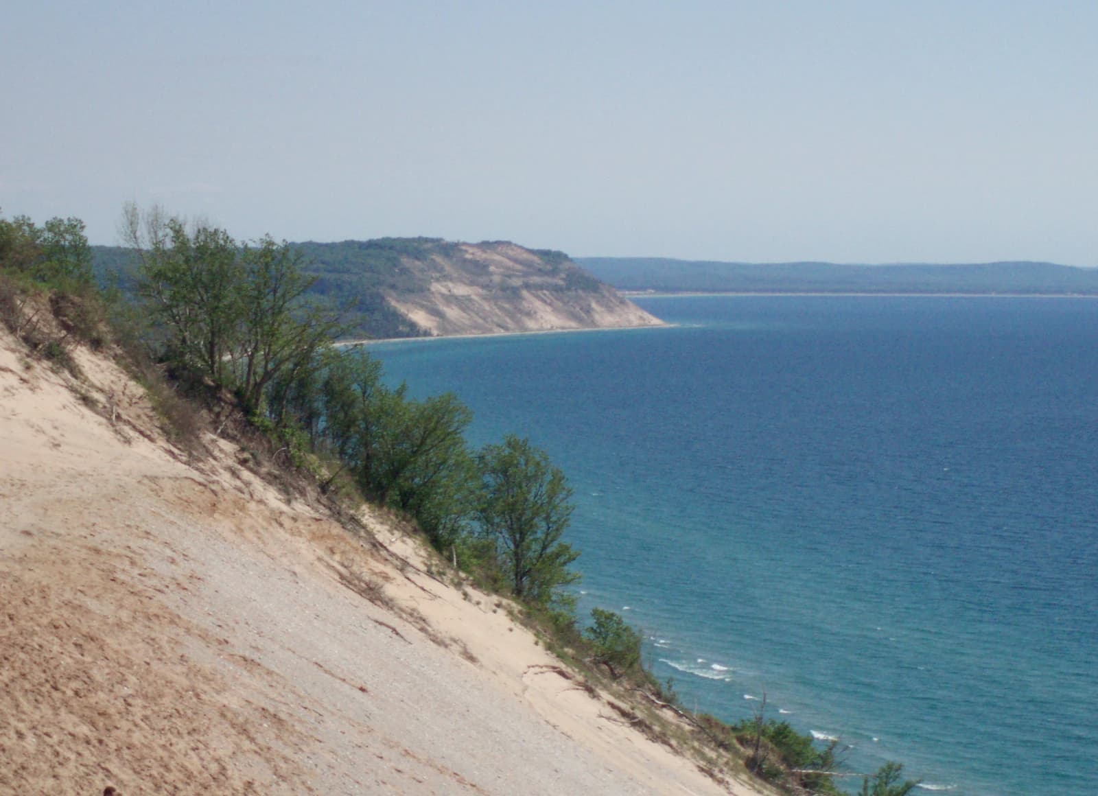 Sand dunes dropping into the turquoise water of Lake Michigan at Sleeping Bear Dunes National Lakeshore