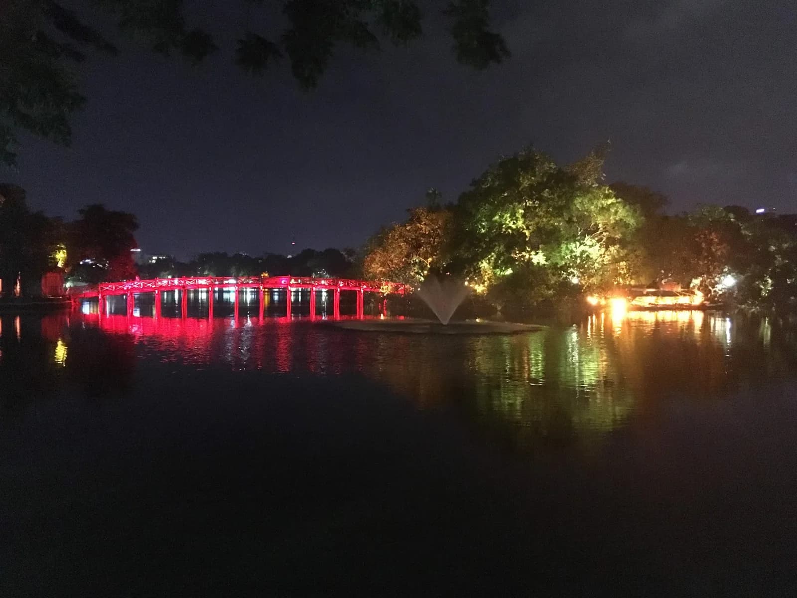 Hoan Kiem Lake at night with the Huc Bridge lit red, the heart of three days in Hanoi