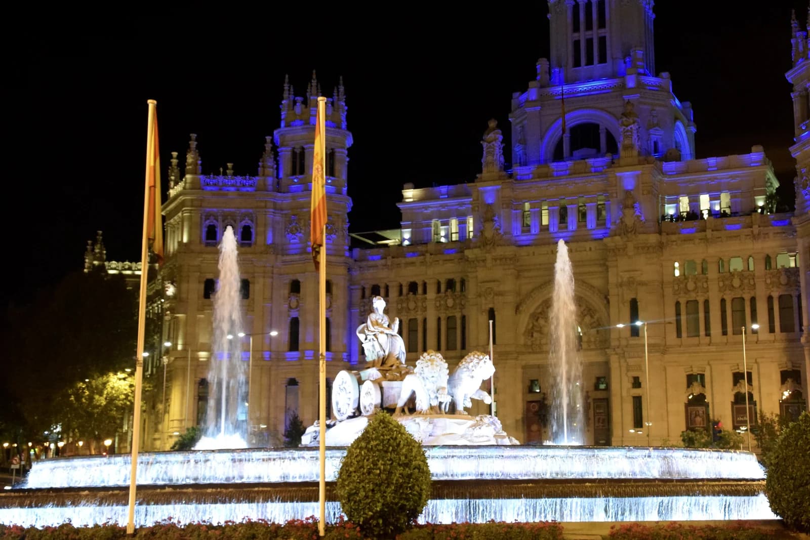 The Cibeles fountain and palace lit at night in central Madrid