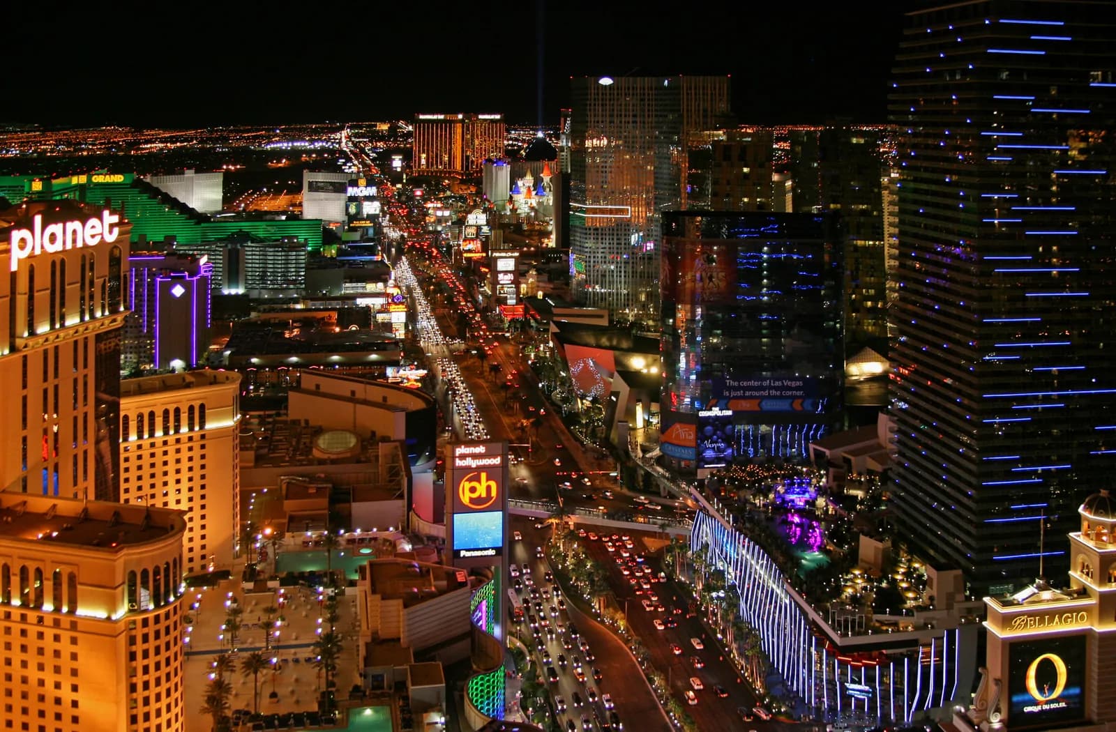 Aerial view of the Las Vegas Strip at night with neon casino lights and glowing hotel towers