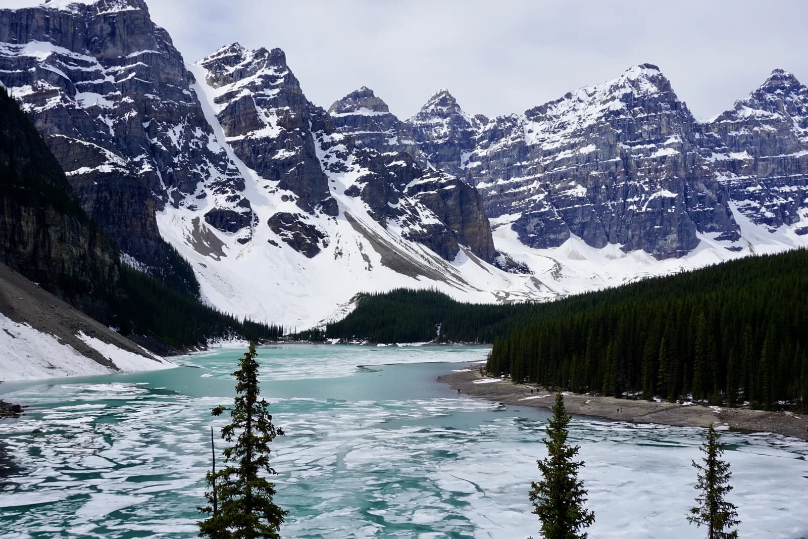 Turquoise water of Moraine Lake in Banff National Park beneath the snow-streaked Valley of the Ten Peaks