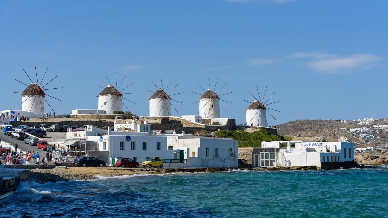 The whitewashed windmills of Kato Mili on Mykonos above a deep blue Aegean Sea