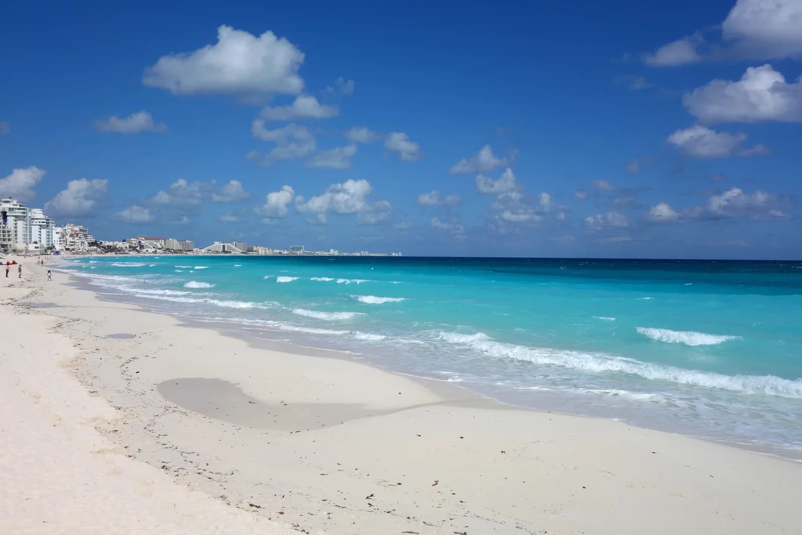 White sand beach and bright turquoise Caribbean water along the Cancun hotel zone
