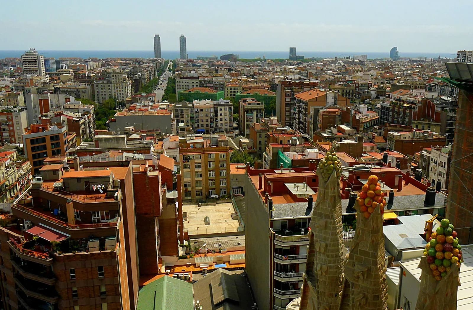 Sagrada Família spires above the rooftops of Barcelona toward the sea