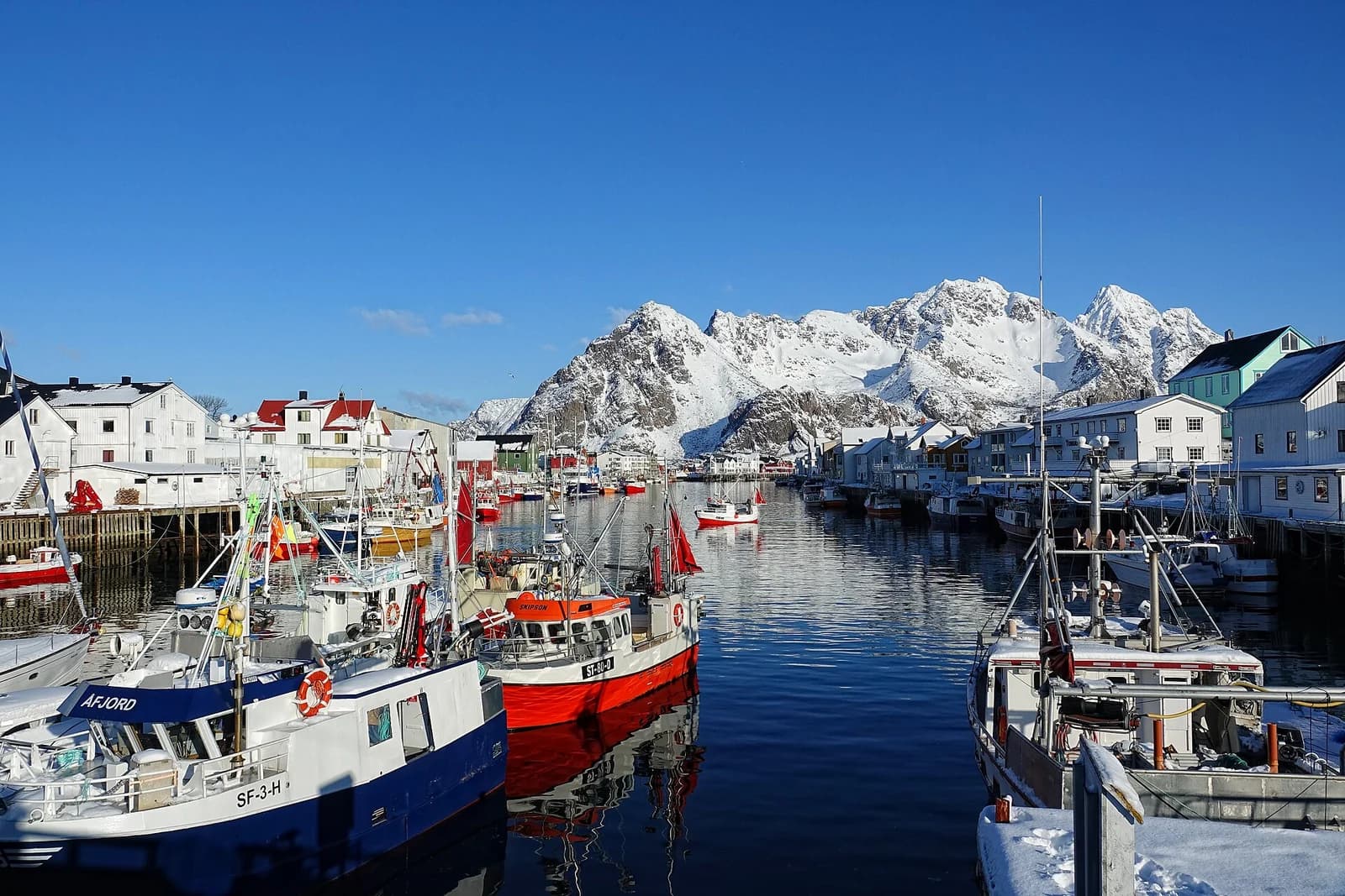The fishing village of Henningsvaer spread across low islands below the mountains of Lofoten