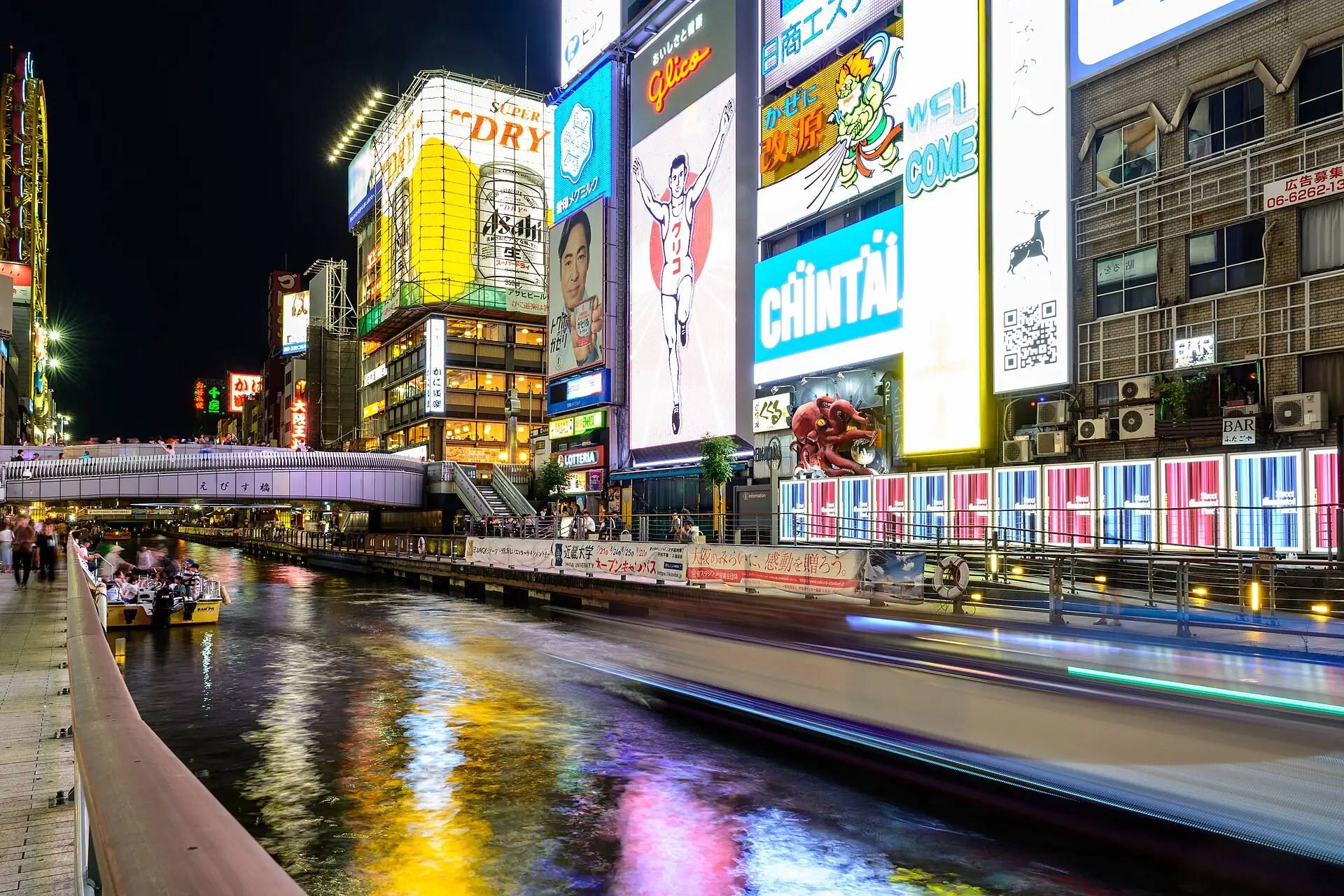 Neon signs reflected in the Dotonbori canal in Osaka at night