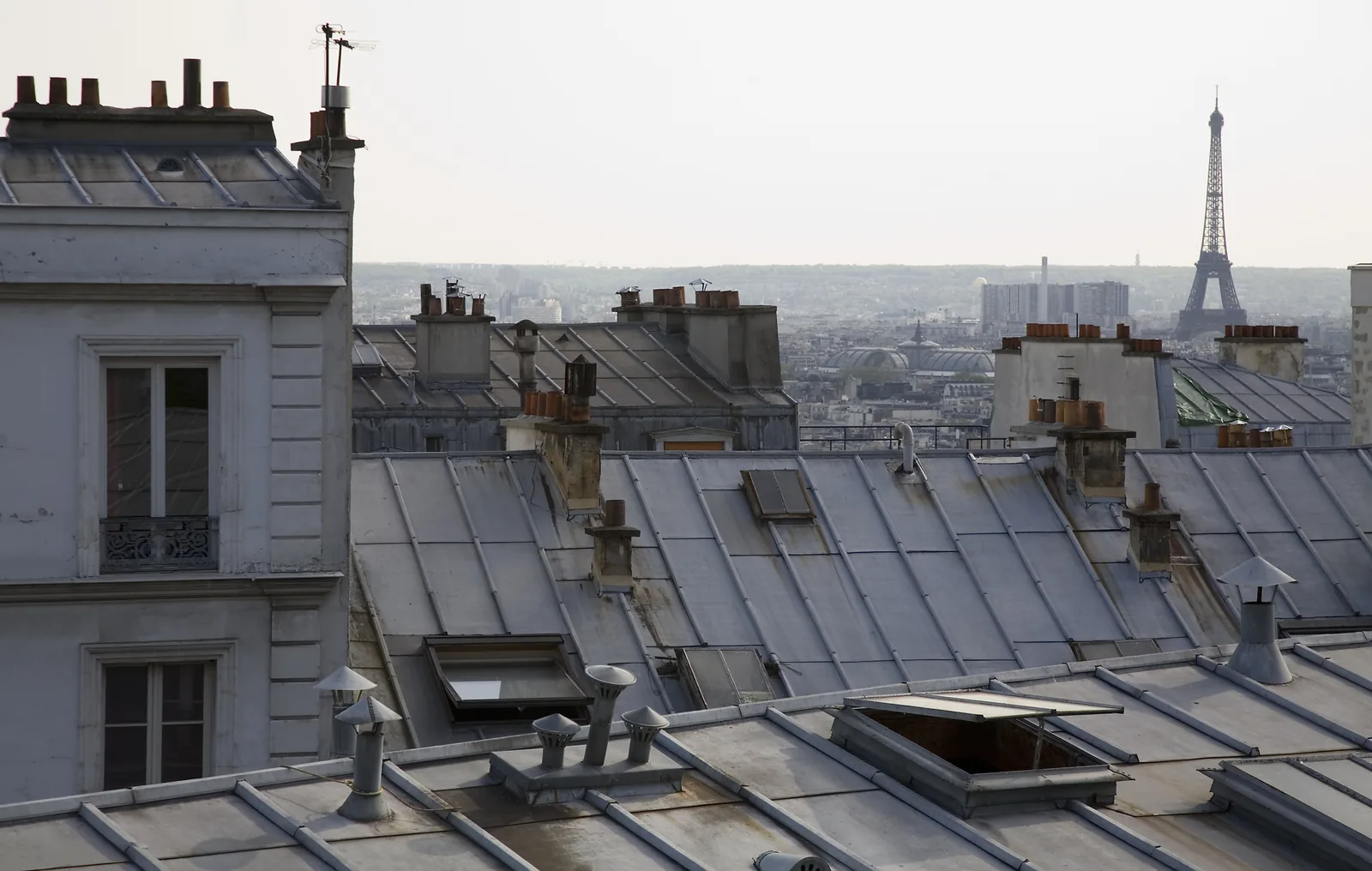 Paris zinc rooftops and chimneys with the Eiffel Tower in the distance