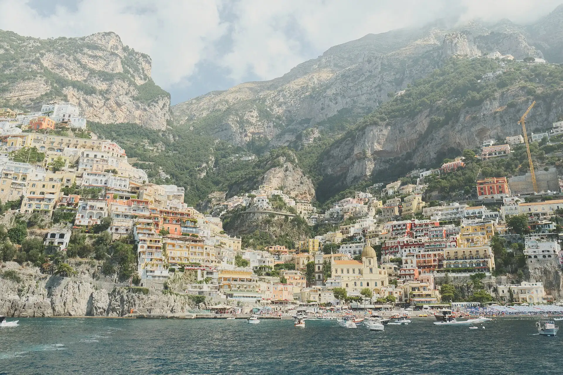 Pastel houses terraced down the cliff to the beach at Positano on the Amalfi Coast