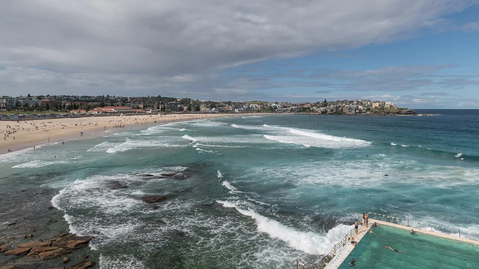 Bondi Beach seen from the southern headland with the surf and the suburb behind it