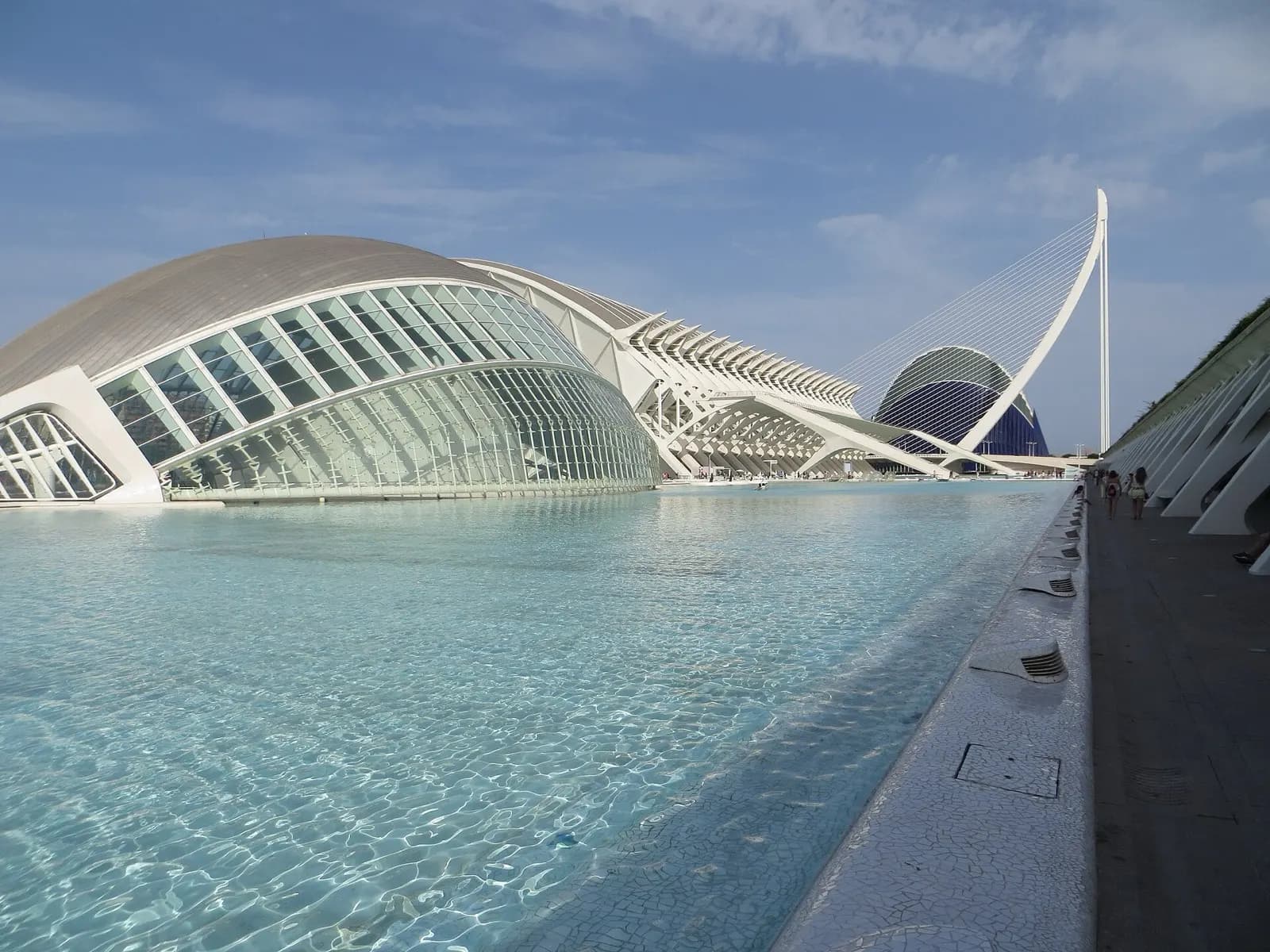 The white curved architecture of the City of Arts and Sciences reflected in its pools, Valencia