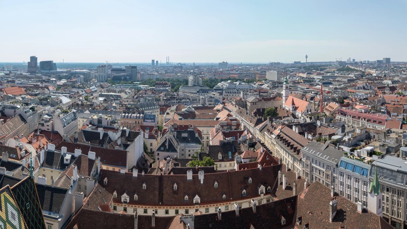 The rooftops of Vienna's first district seen from the south tower of St Stephen's Cathedral, with the cathedral's tiled roof in the foreground