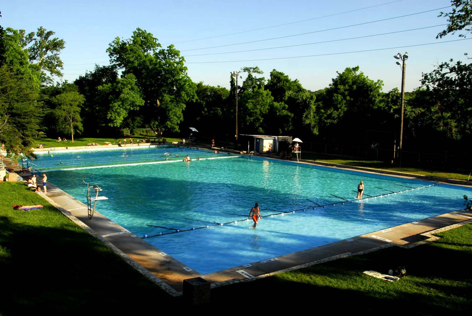 Swimmers in the spring-fed rectangular pool and the shallow wading pool at Deep Eddy in Austin