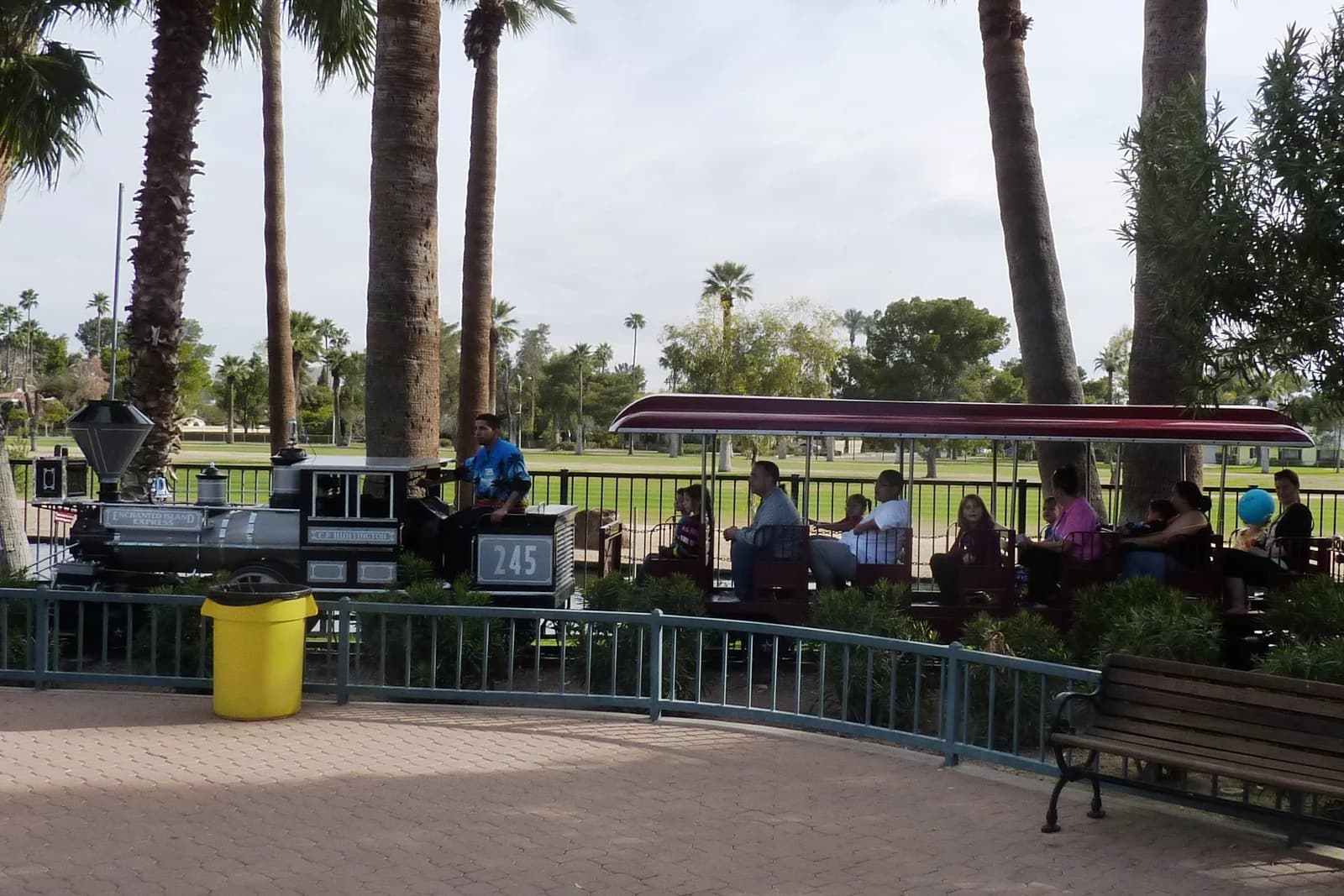 Families riding the miniature train at Enchanted Island in Encanto Park, Phoenix