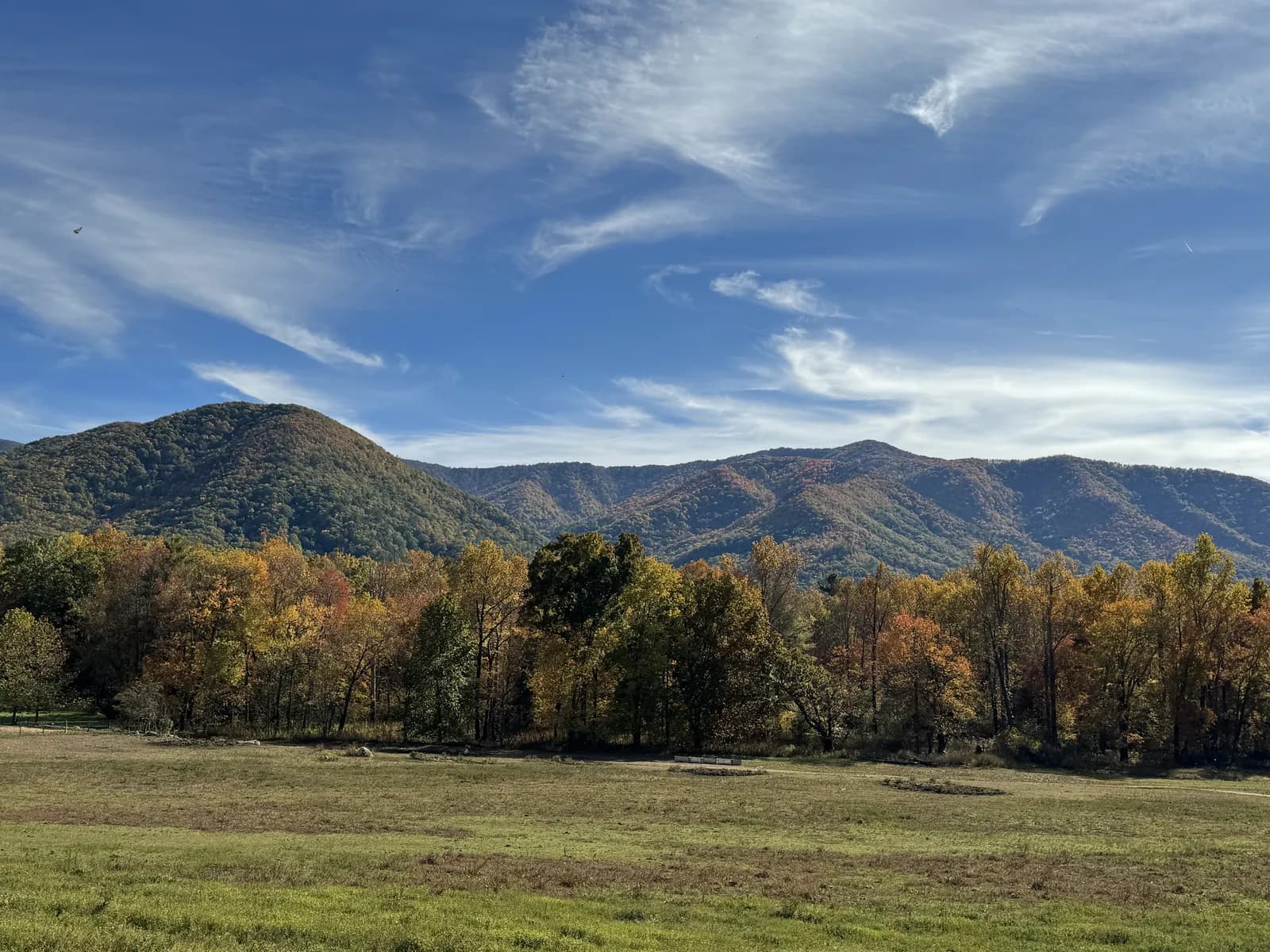 Autumn colour and the Smoky Mountains above the open valley at Cades Cove
