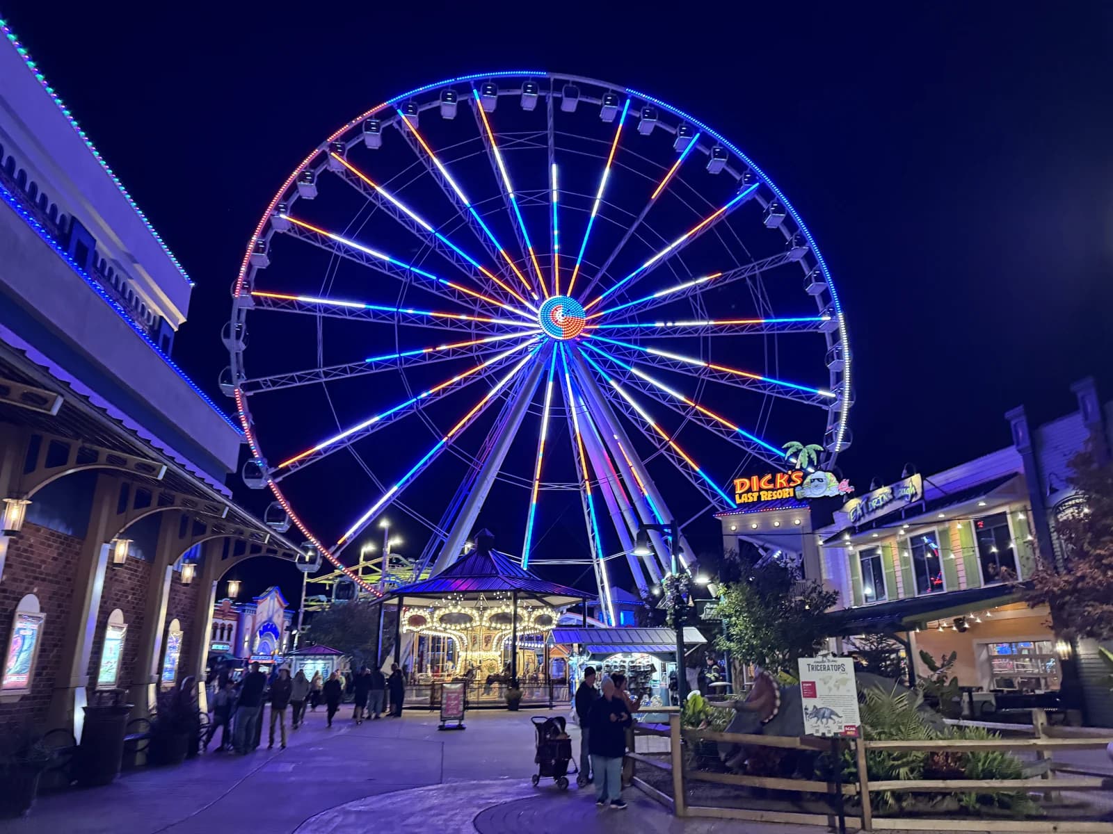 The Great Smoky Mountain Wheel lit at night above The Island complex in Pigeon Forge