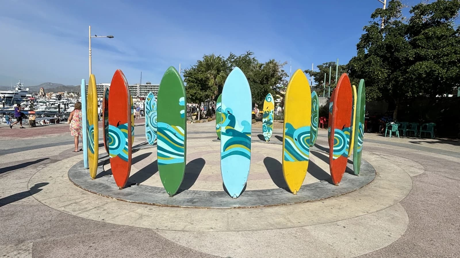 A ring of painted surfboards standing beside the harbour walk in Cabo San Lucas