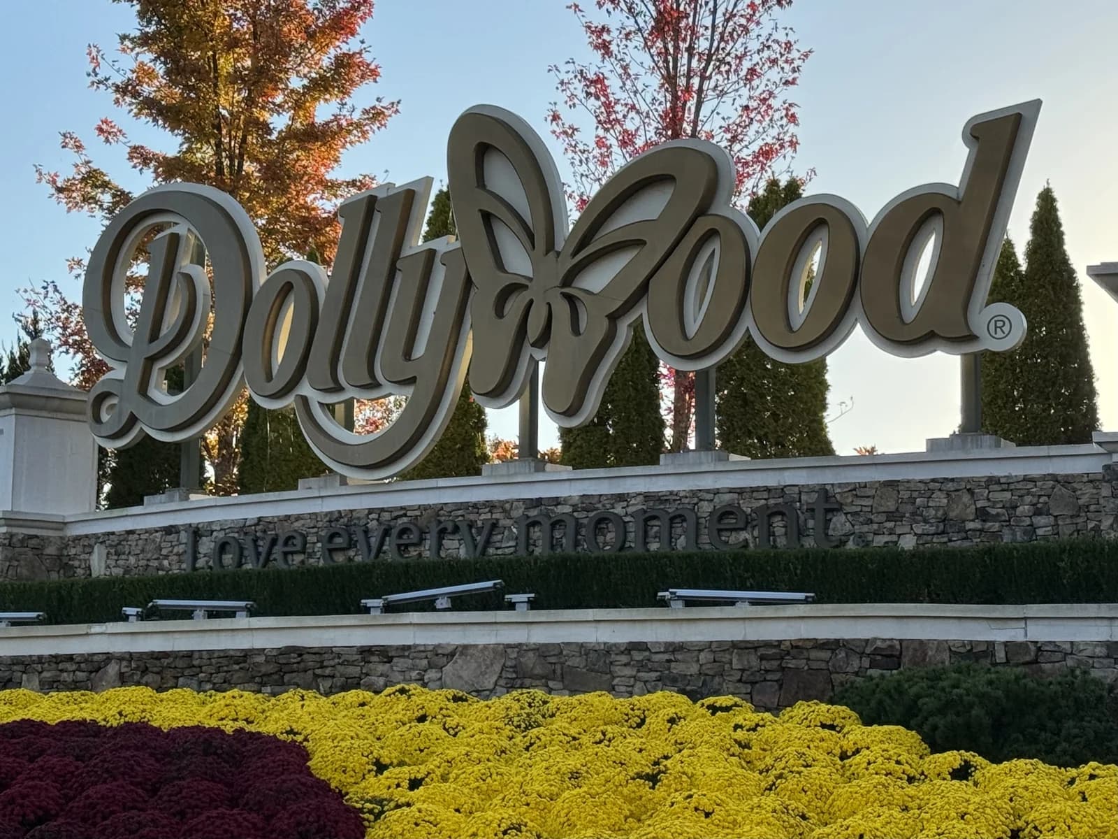 The Dollywood entrance sign above autumn flower beds in Pigeon Forge