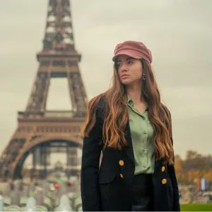 Emma, who writes the Journey Finder hotel guides, standing on a Paris street with the Eiffel Tower behind her
